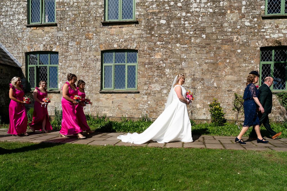 Bride and Bridal party walking to the chapel at Ash Barton Estate in Devon.