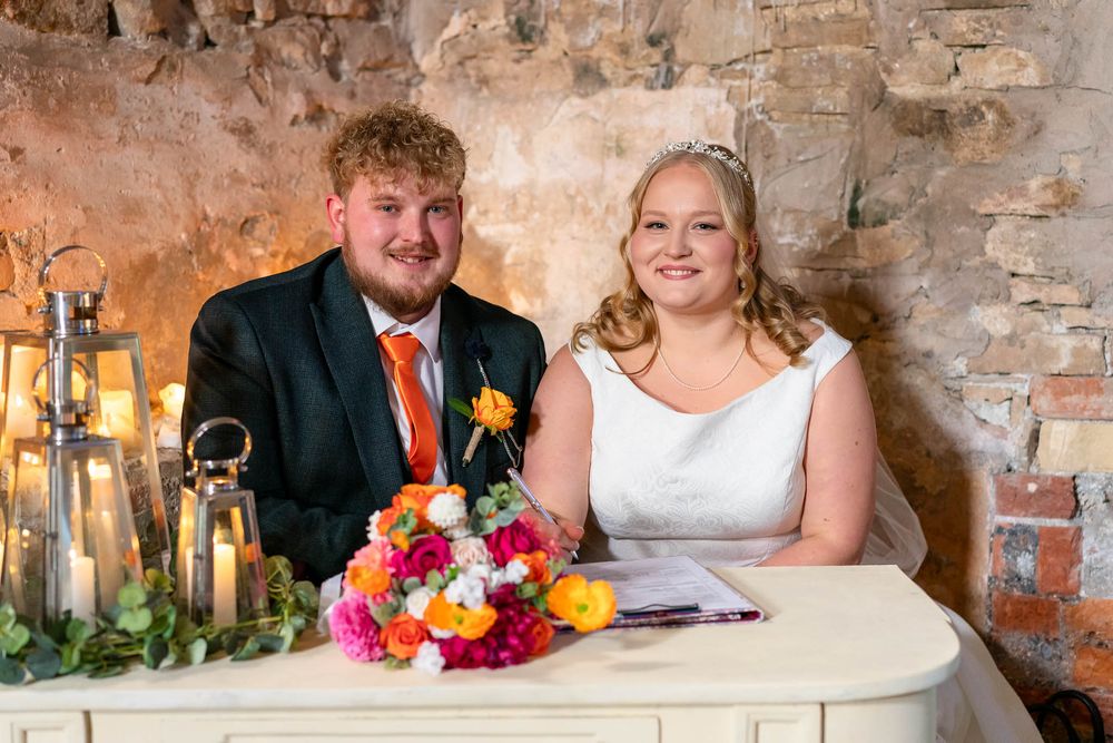 The new Mr and Mrs in the chapel at Ash Barton Estate about to sign the register.