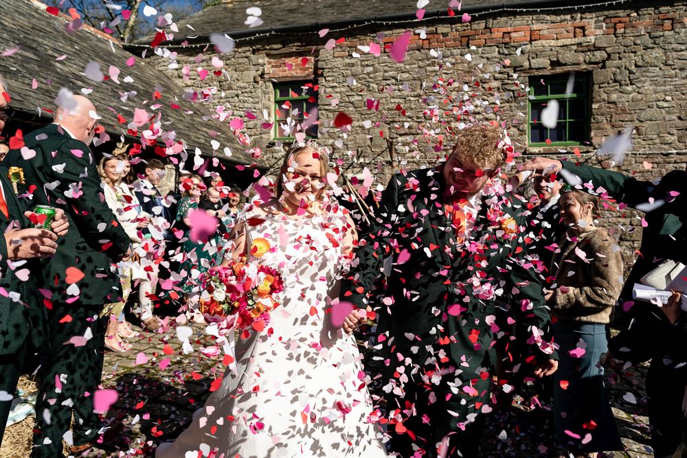 Lots of confetti being thrown at Ash Barton Estate Wedding in Devon.