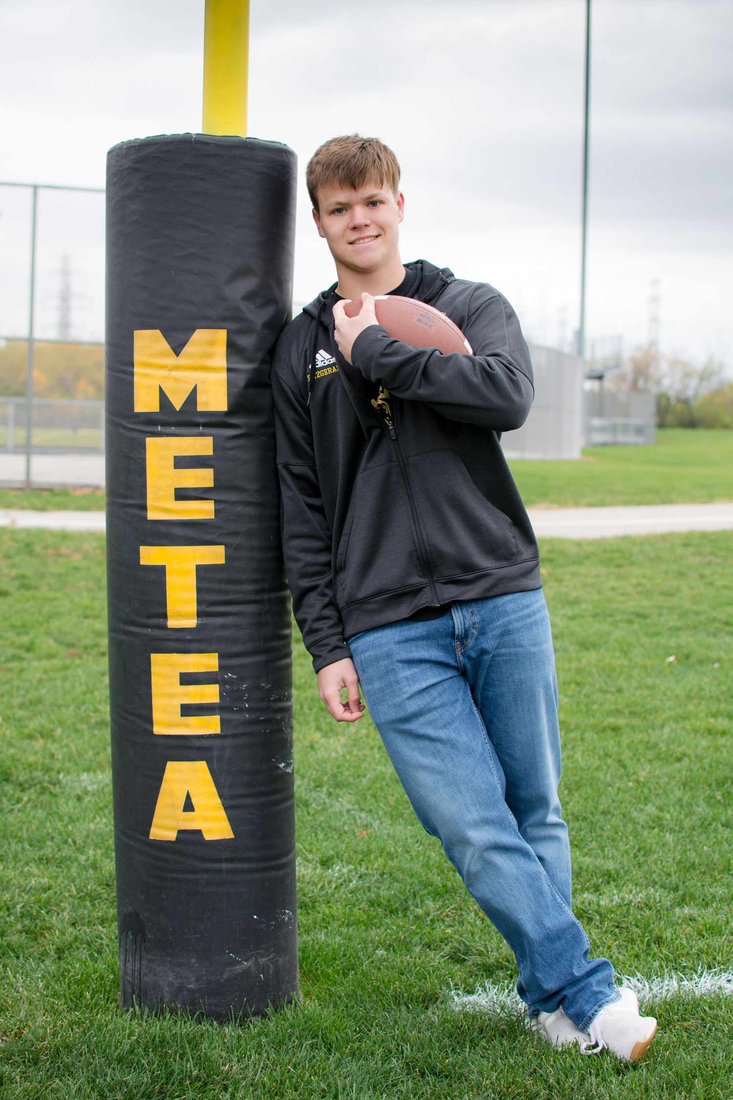 Senior Boy on the football field photography session, Aurora, IL.