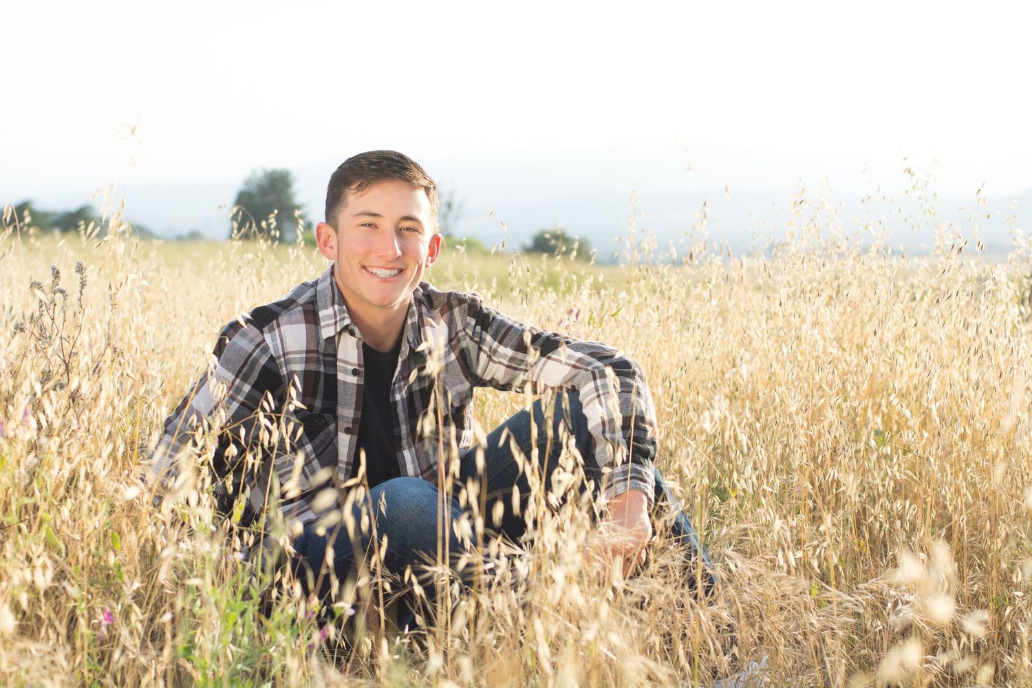Senior Boy Fall Photography session in a field.