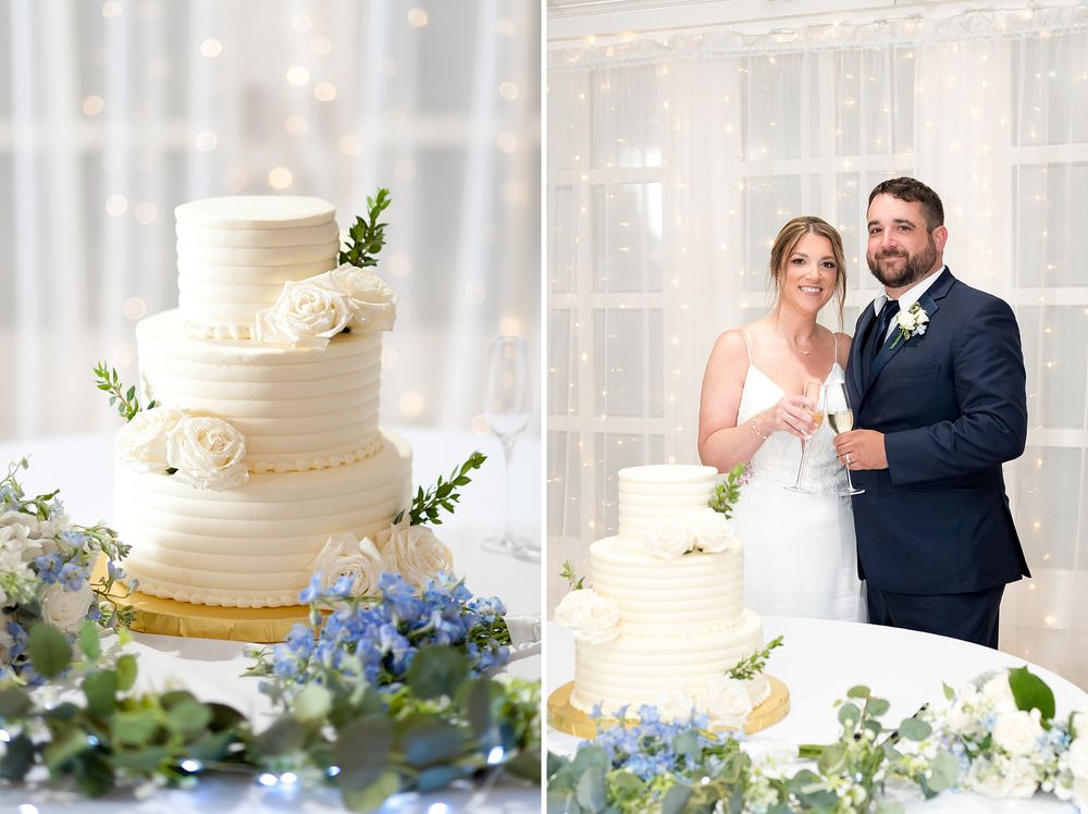 Elegant three-tier white wedding cake with roses displayed beside a smiling bride and groom.