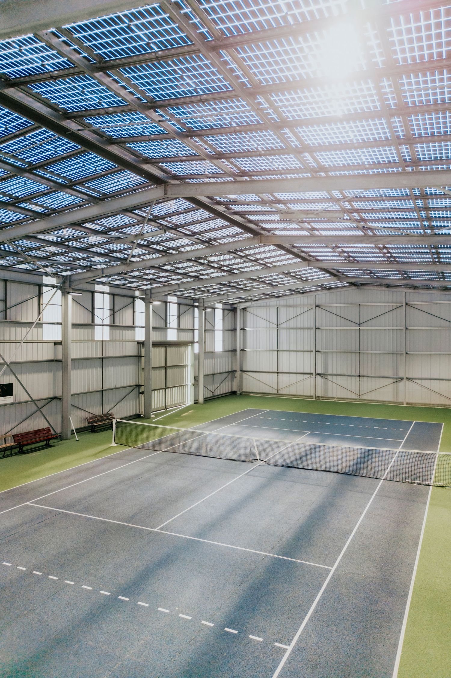 Structure intérieure d’une ombrière photovoltaïque couvrant des terrains de tennis. Reportage photo par Autan Blanc.