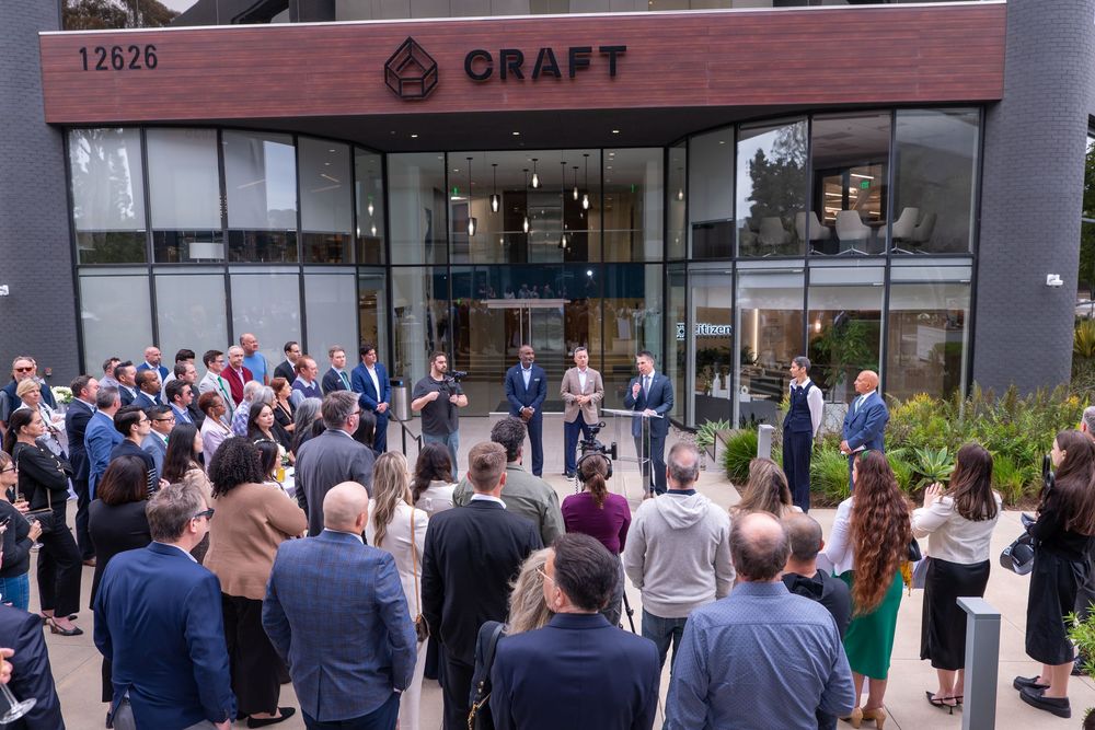 Crowd gathers outside Craft building at 12626 for an outdoor corporate event or grand opening.