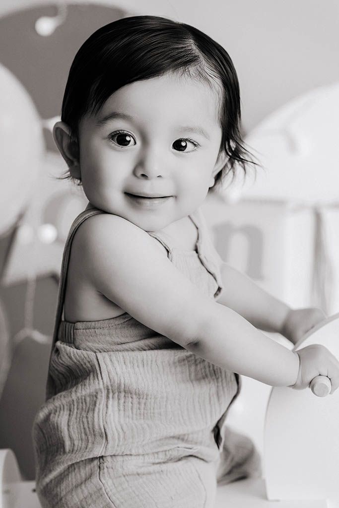 Black and white portrait of cute one year old baby boy by affordable 1st birthday photographer in Menifee California.