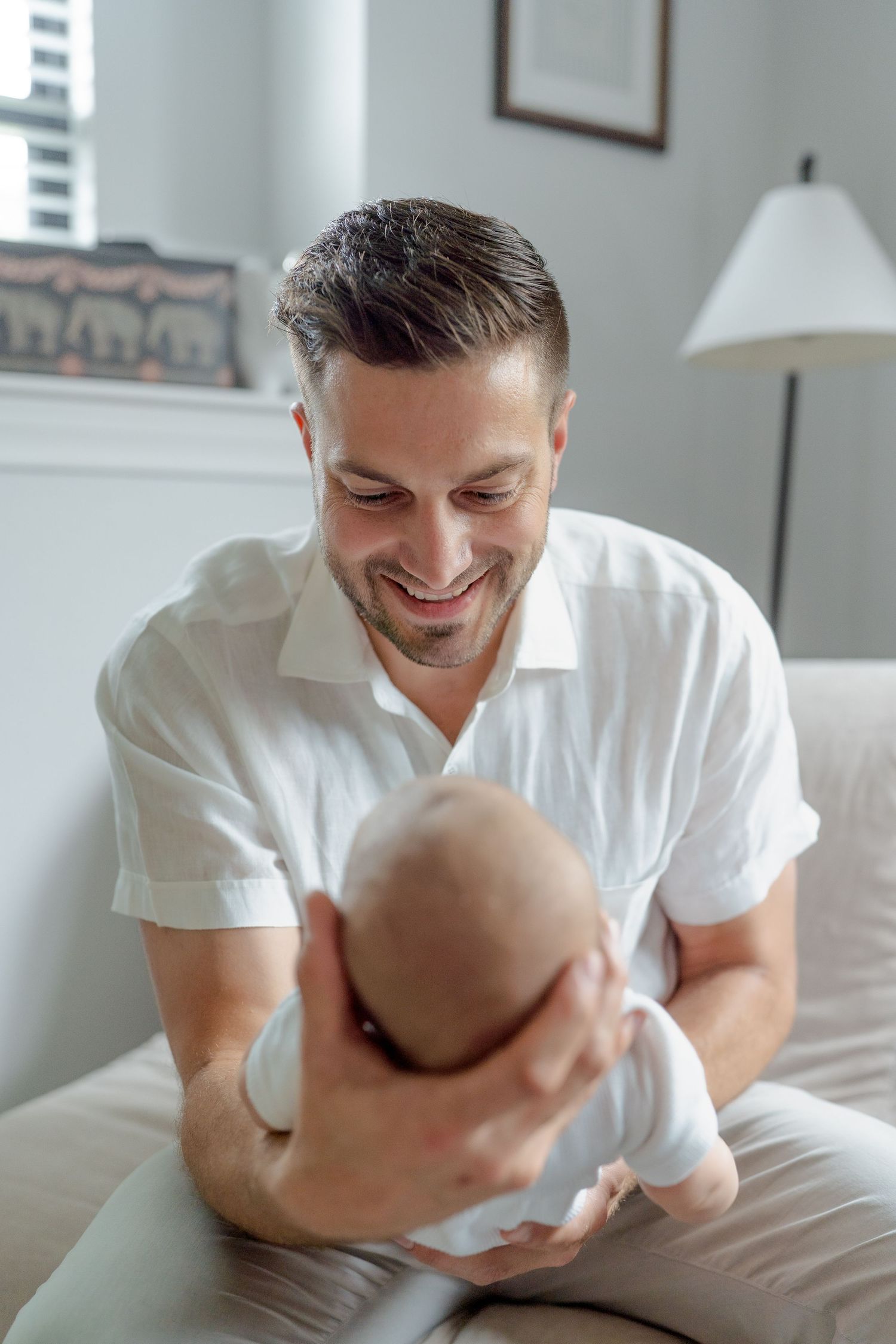 Dad holding newborn baby in arms
