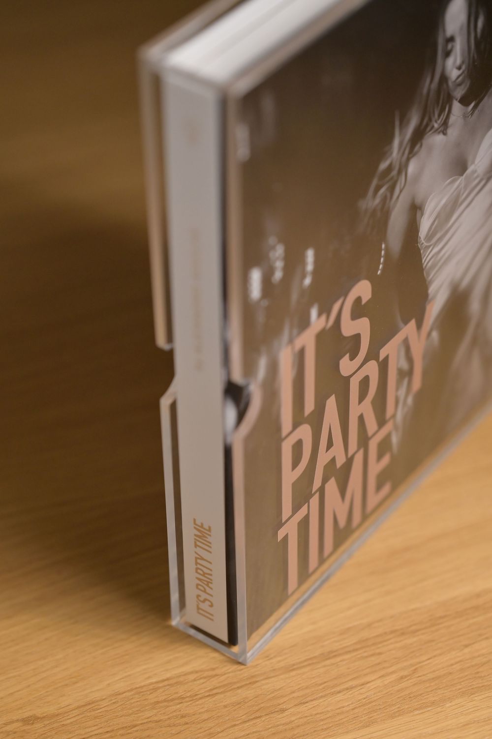 Its Party Time hardcover photo book in a clear acrylic protective display case.