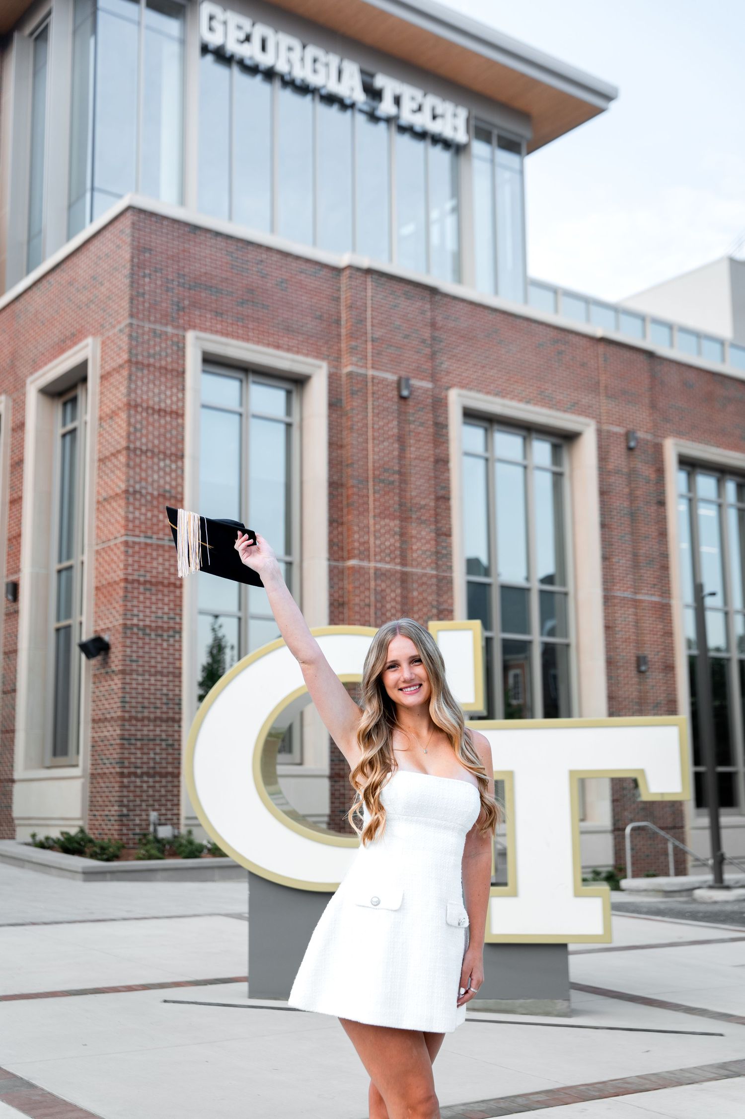Smiling graduate poses for the best Atlanta grad photos at Georgia Tech with portraits by Pierre The Pear Photography