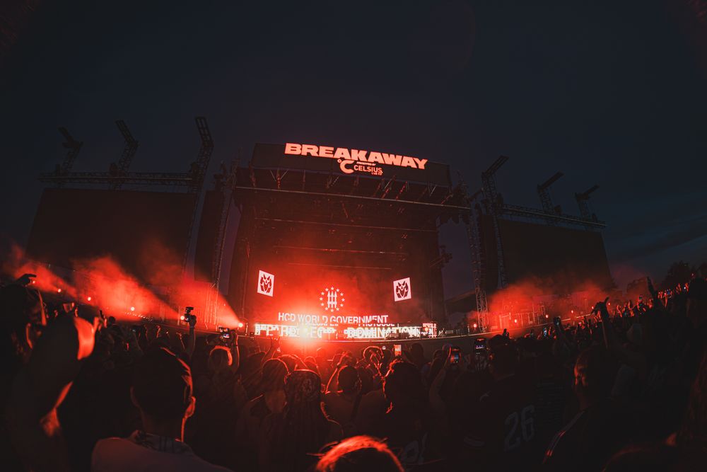 Breakaway Music Festival stage lit in red light with massive crowd at night.