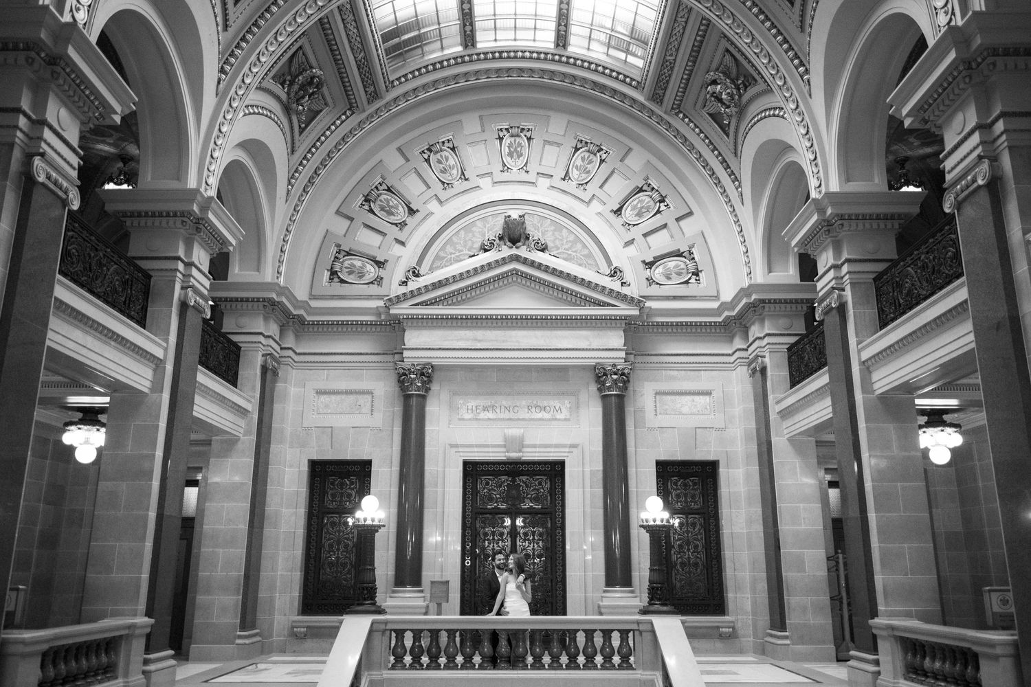 Elegant black and white interior of a grand marble hall with arched ceilings and ornate architectural details at Manitoba Building.
