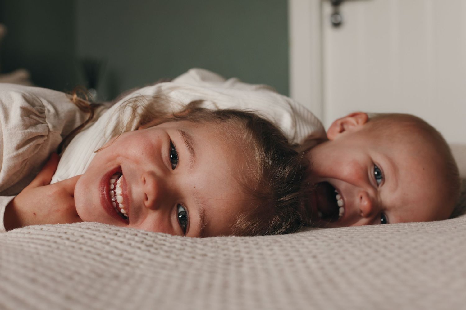 Relaxed sibling cuddles at home family photography session