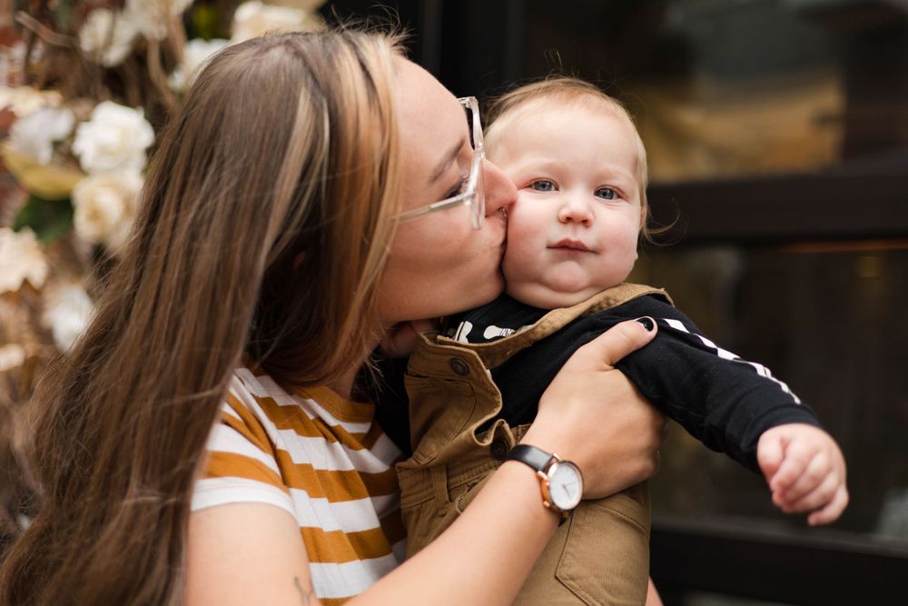 A tender moment captured between parent and child in an intimate portrait.