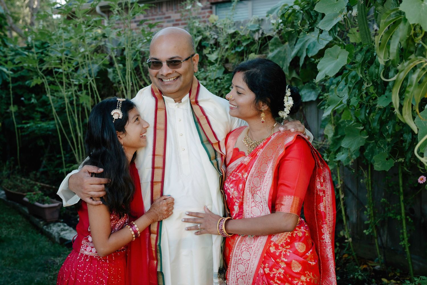 Traditional Indian celebration in a garden setting with bright decorations and festive attire.
