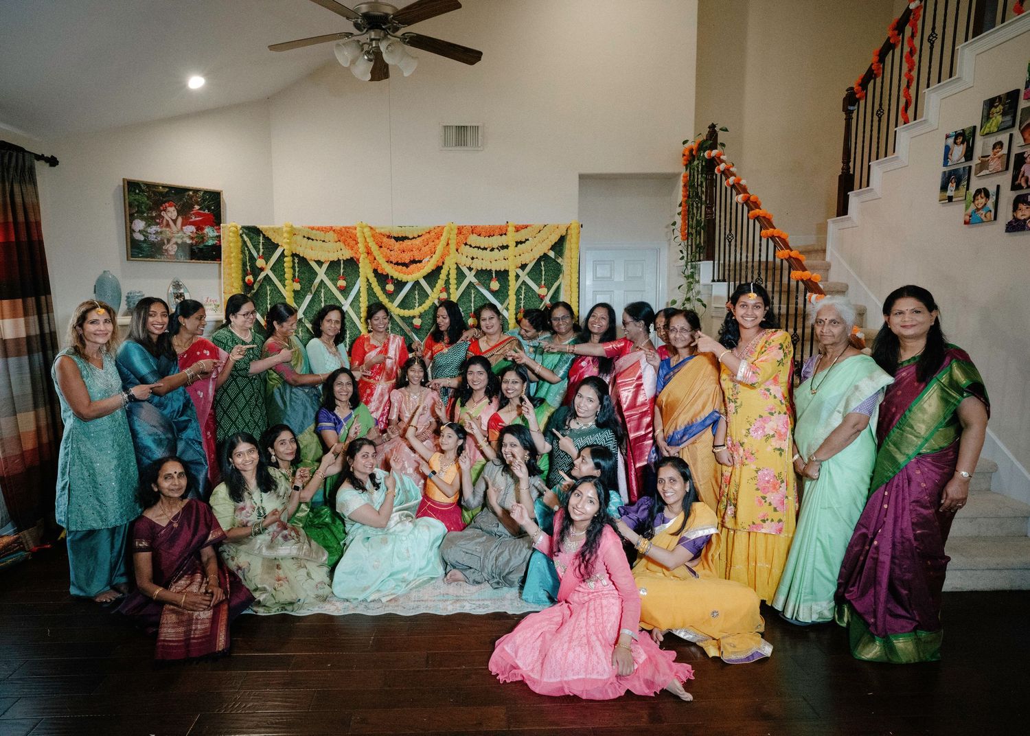 Colorful celebration with guests in traditional Indian attire dancing and enjoying festivities at an indoor venue.