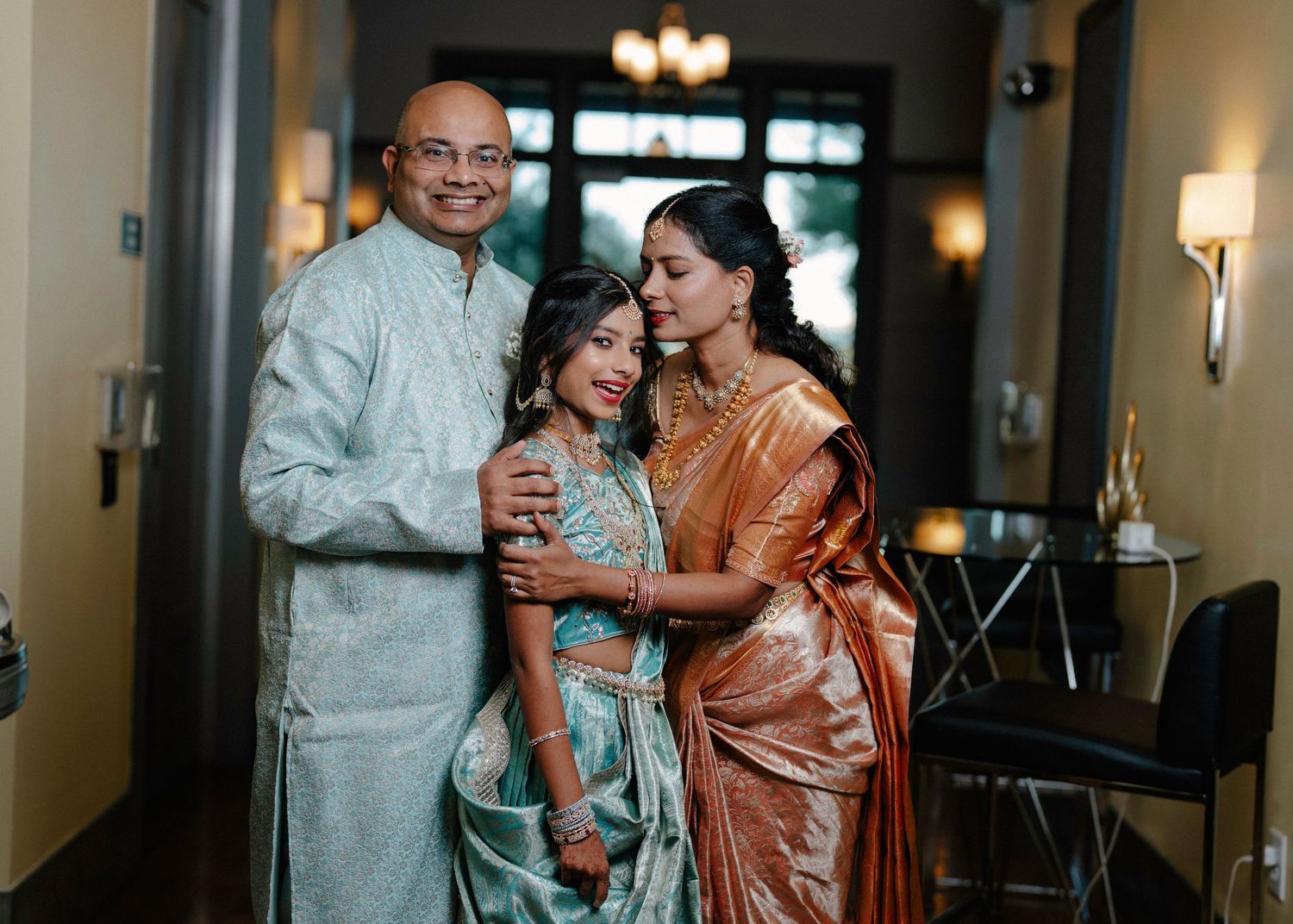 Elegant indoor celebration with formal attire and warm lighting.