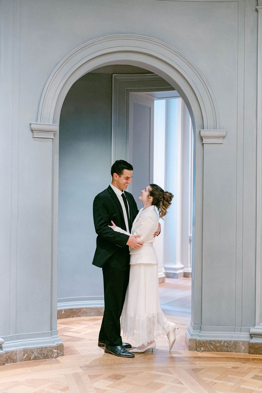 A series of photos showing a couple dancing in an elegant room with arched doorways.