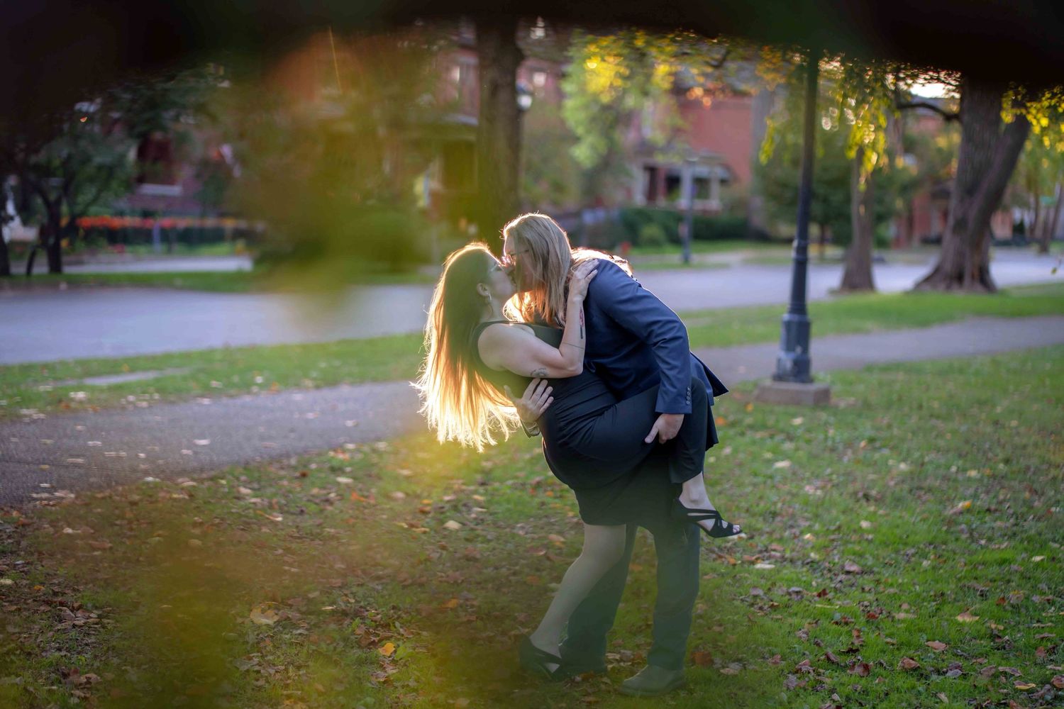 A romantic couple dip and pose for their engagement photo