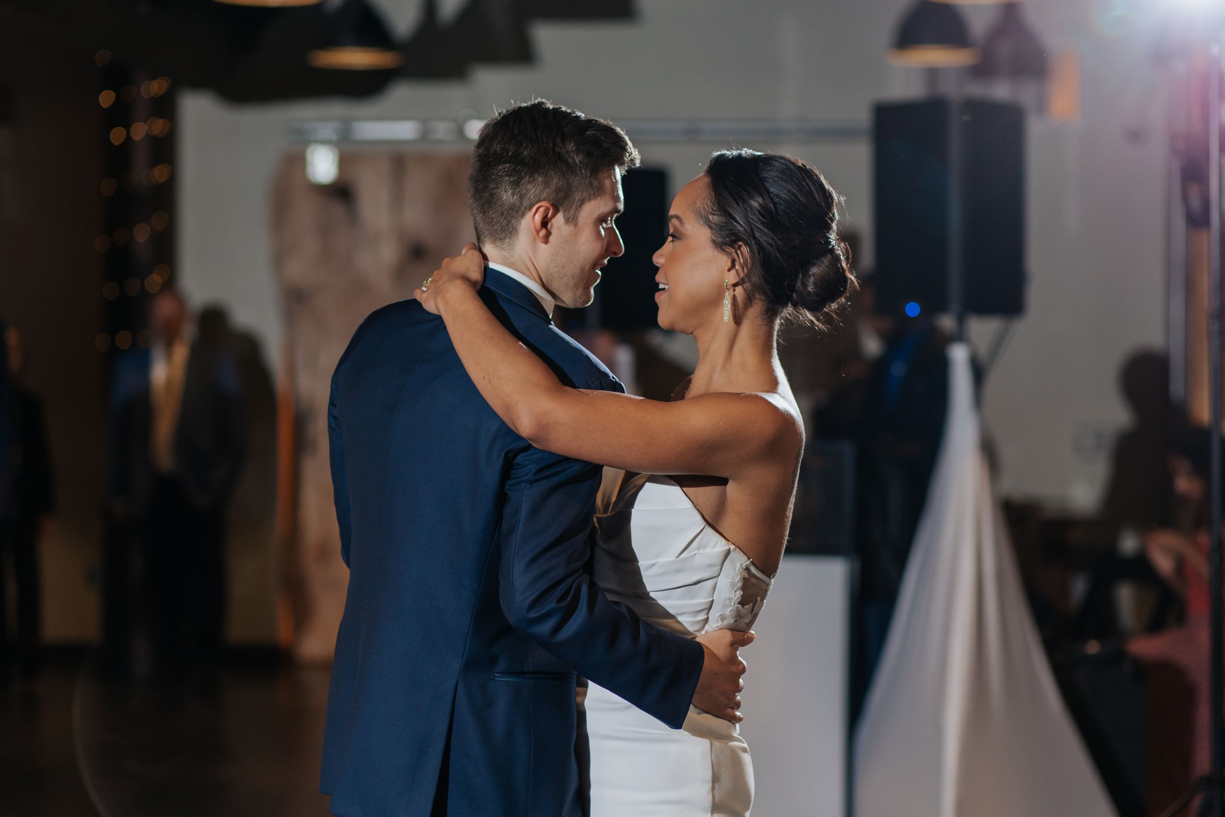 Romantic first dance at a wedding reception with soft lighting and intimate atmosphere.