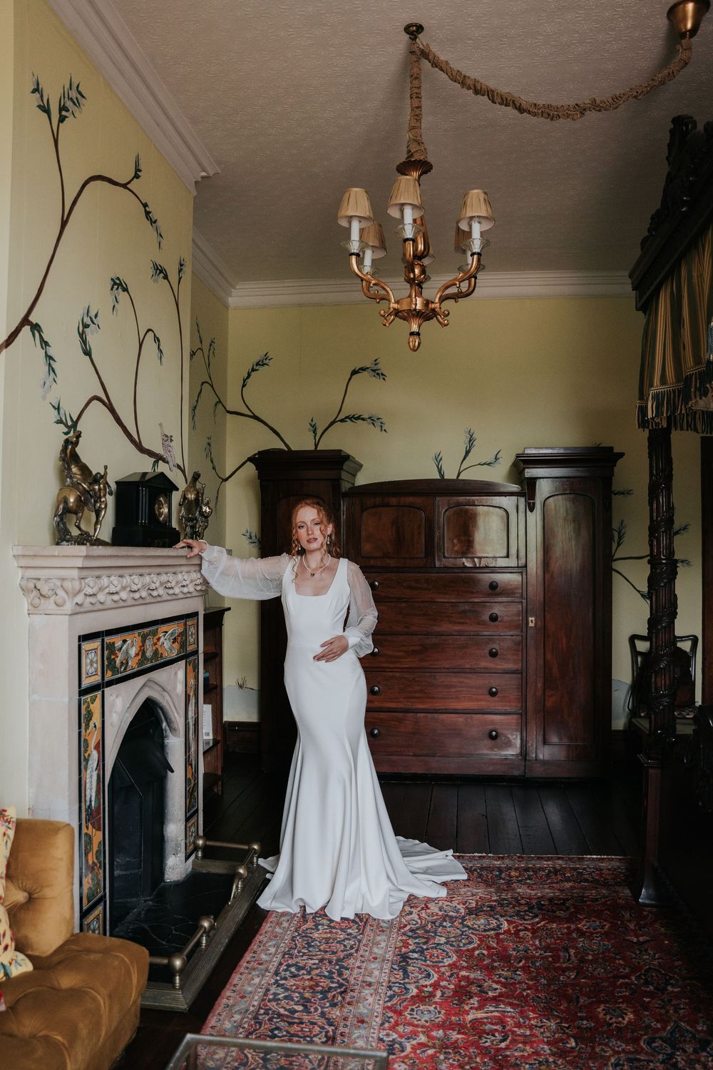 Bride in modern square neckline wedding dress in luxury bedroom at Huntsham Court wedding venue