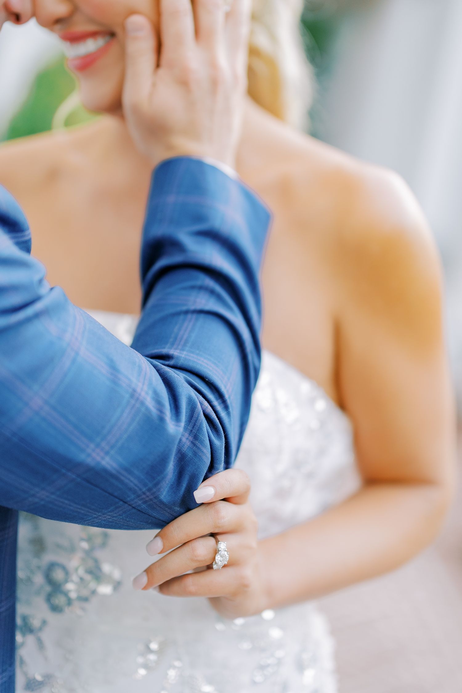 Close-up shots of a couple in wedding attire holding hands and showing their wedding rings.