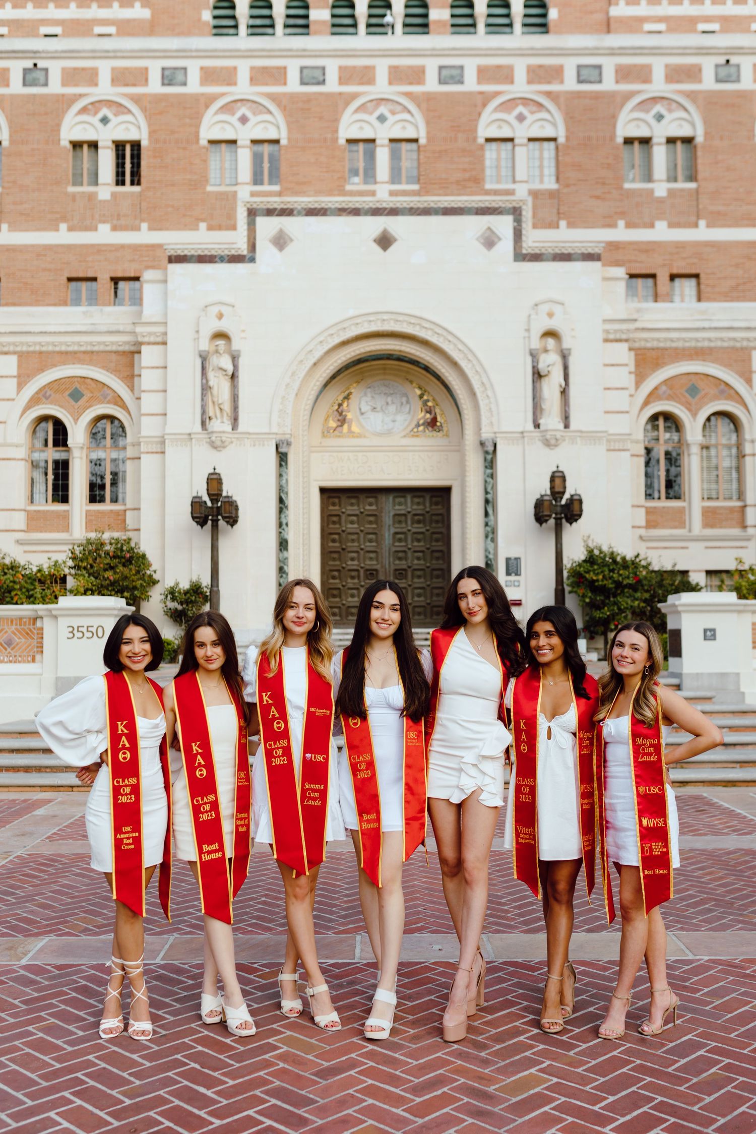 USC group of college graduates pose for their grad photoshoot together. Grad photos taken by Bay Area Graduation Photographer.