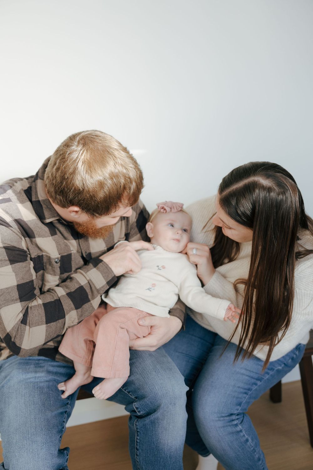 A series of four photos showing the proper steps for performing the Heimlich maneuver on an infant.