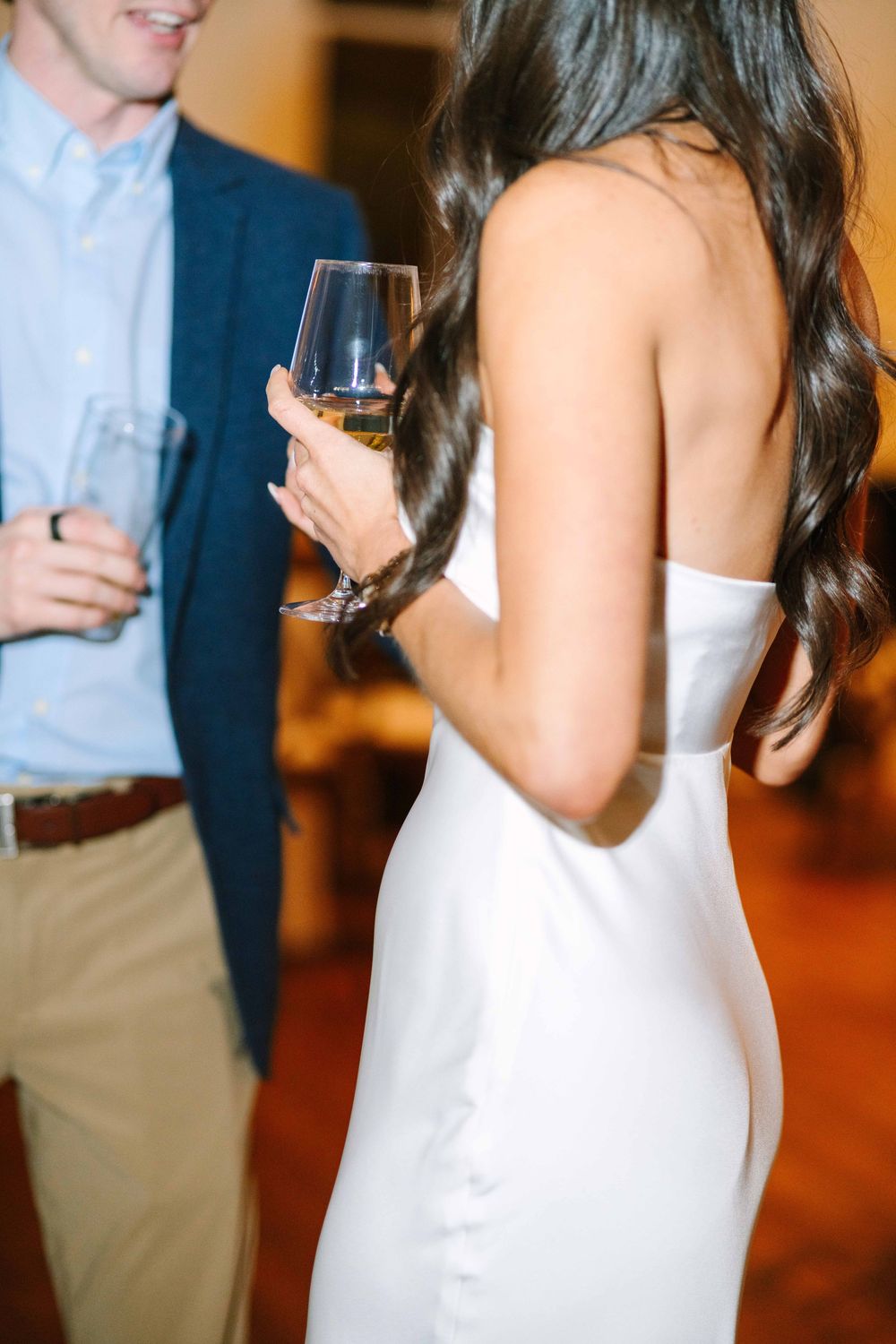 Candid reception moments showing formal attire and wine glasses.