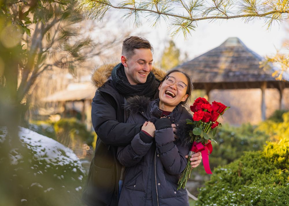 Engagement photo of a couple laughing together at UIUC Japan House