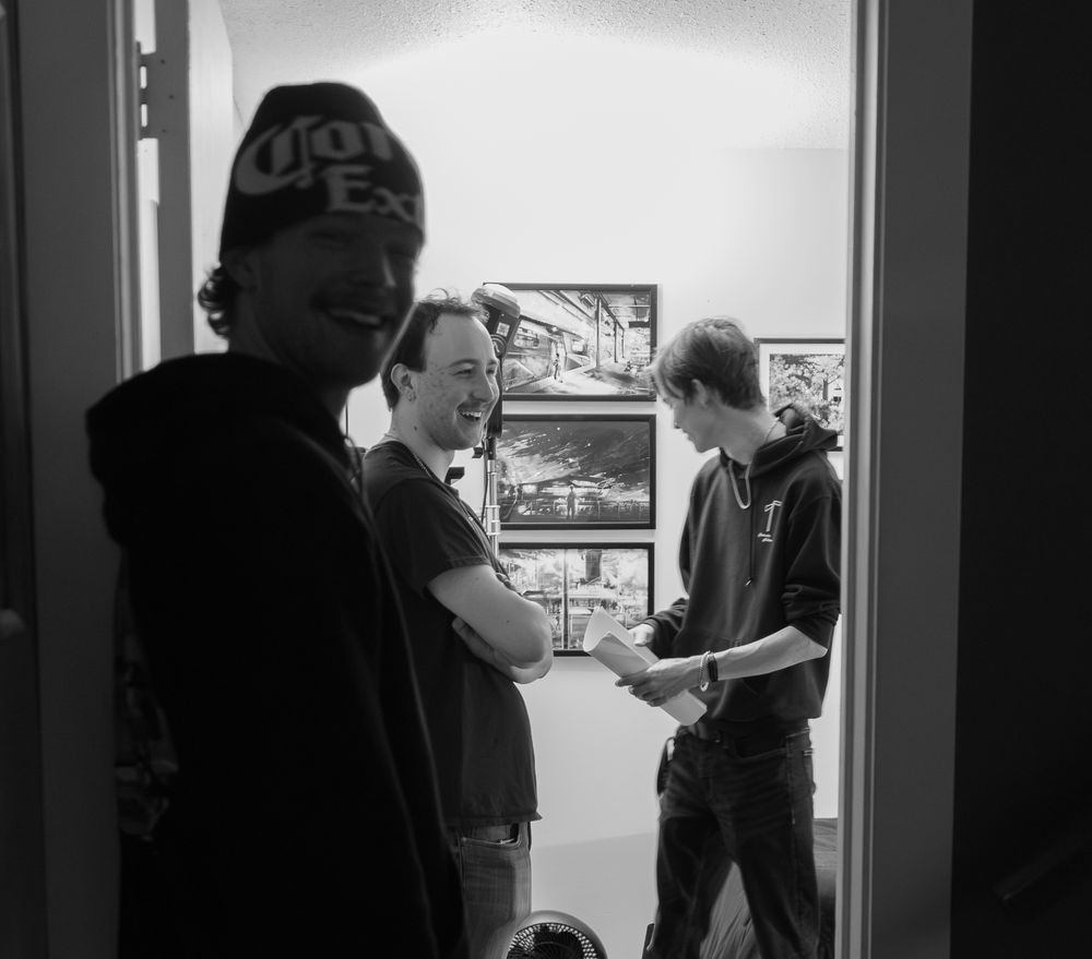 Group discussing in a hallway during film production.