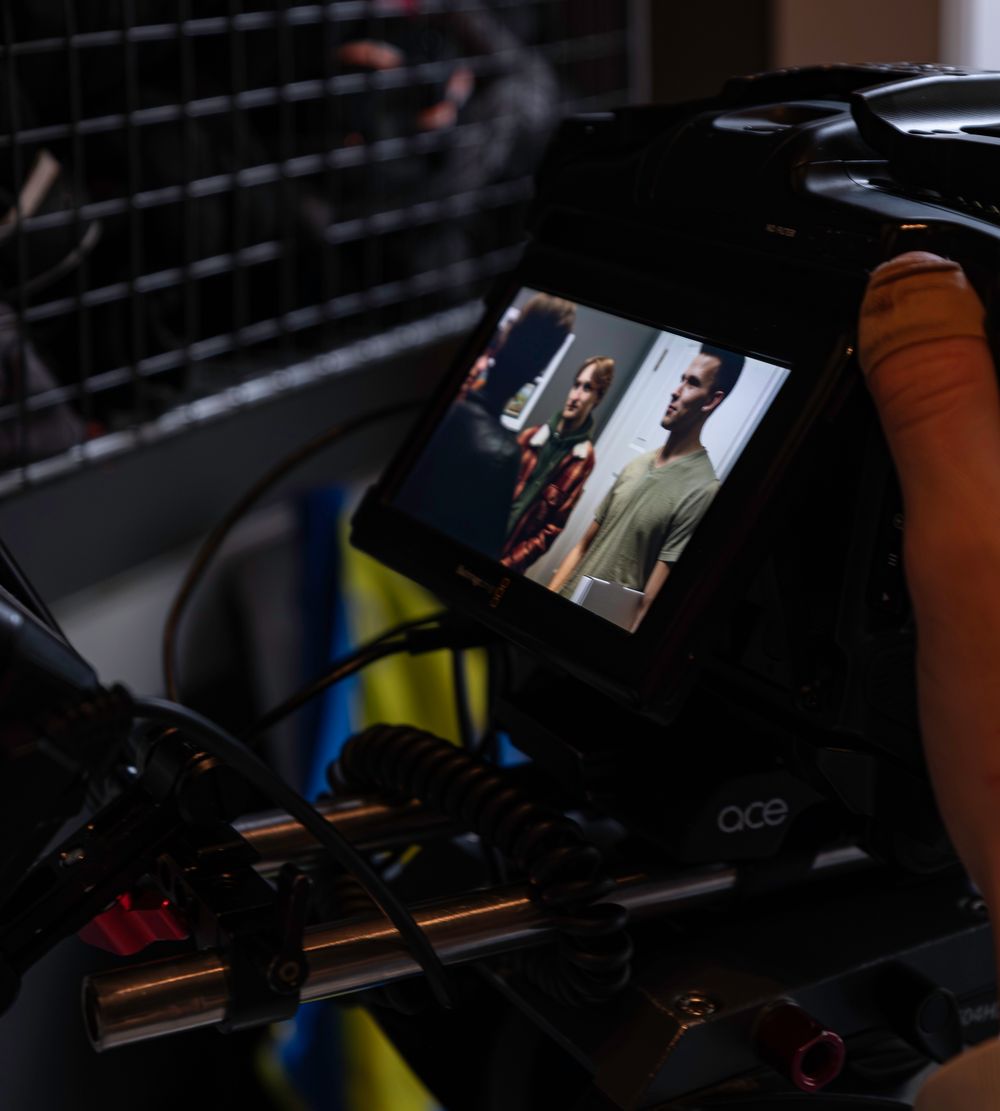 Dark shot of video production monitors and camera equipment during filming.