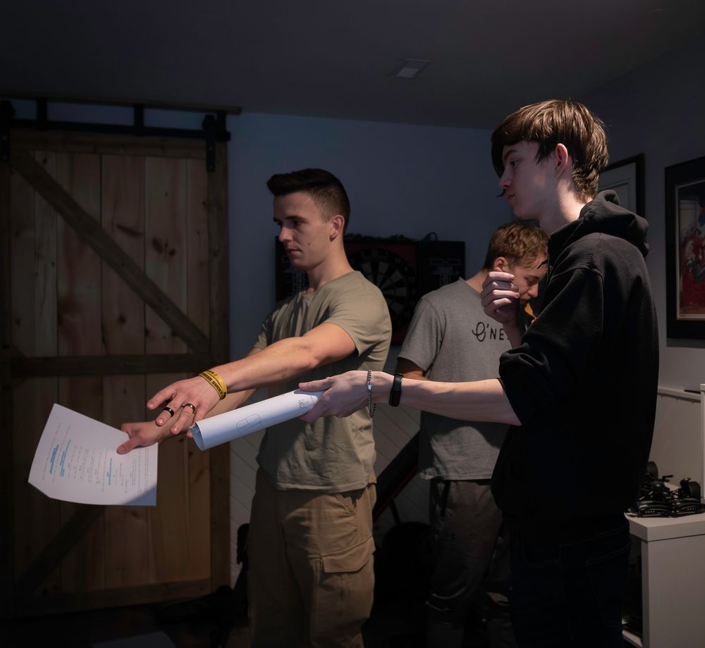 Production team filming in low light conditions with professional equipment.