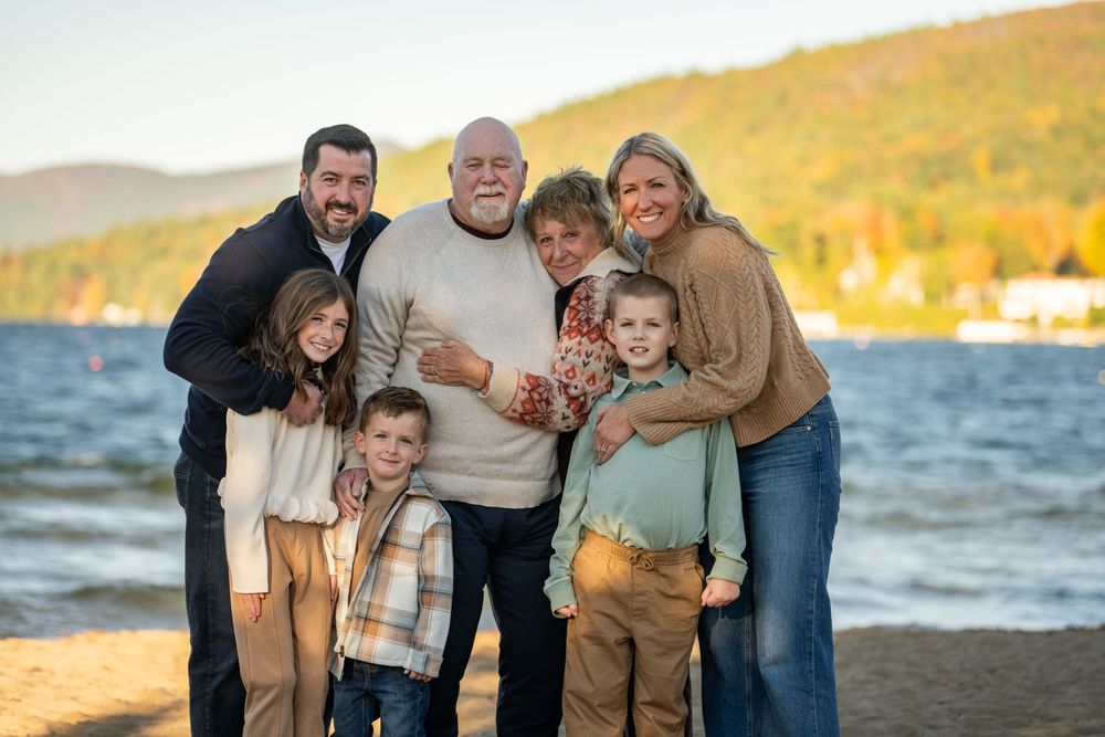 Family enjoying sunset moments together at the beach during a golden hour photo session.