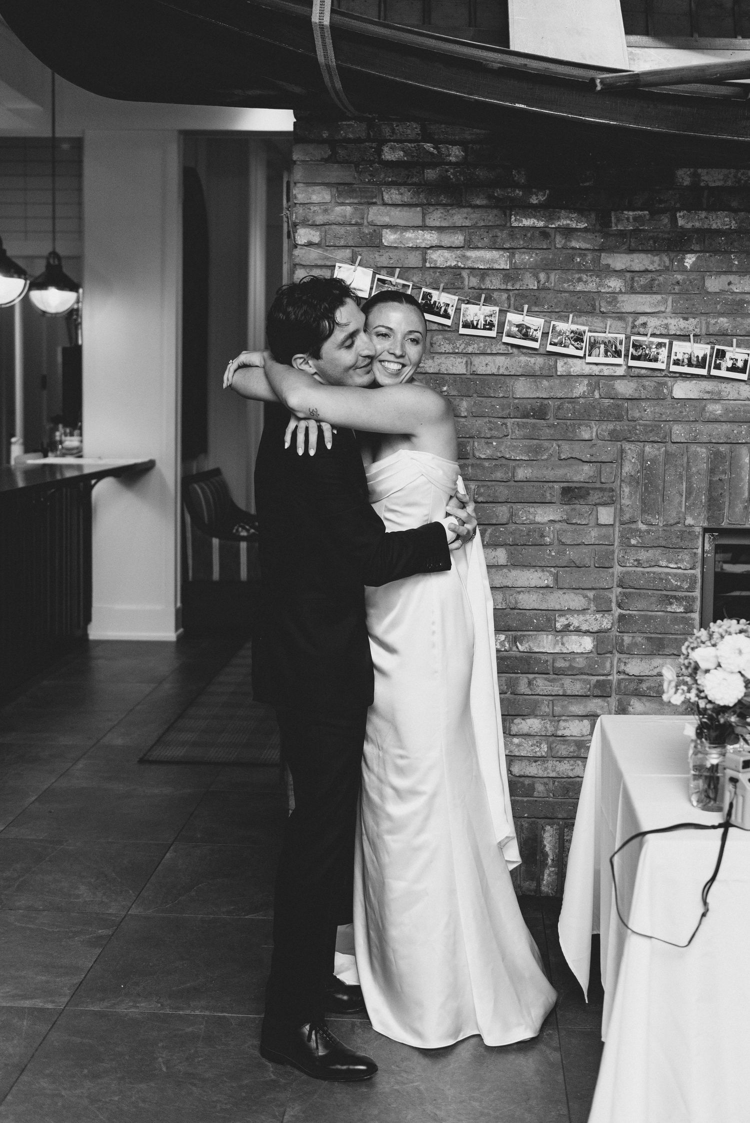 A sequence of black and white wedding photos showing a couple dancing and embracing at their reception.