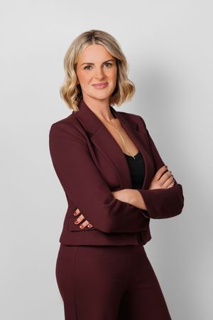 Series of casual business poses in a maroon blazer showing confident and friendly expressions.