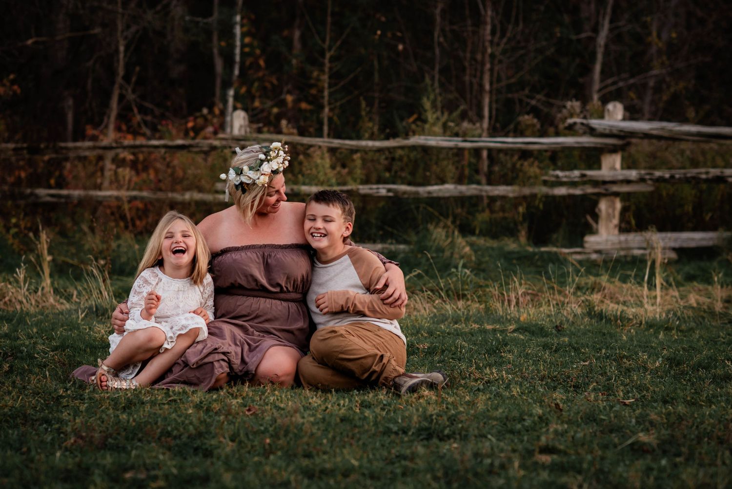 A mother laughing with her two children on their family farm on Beaverton, Ontario.
