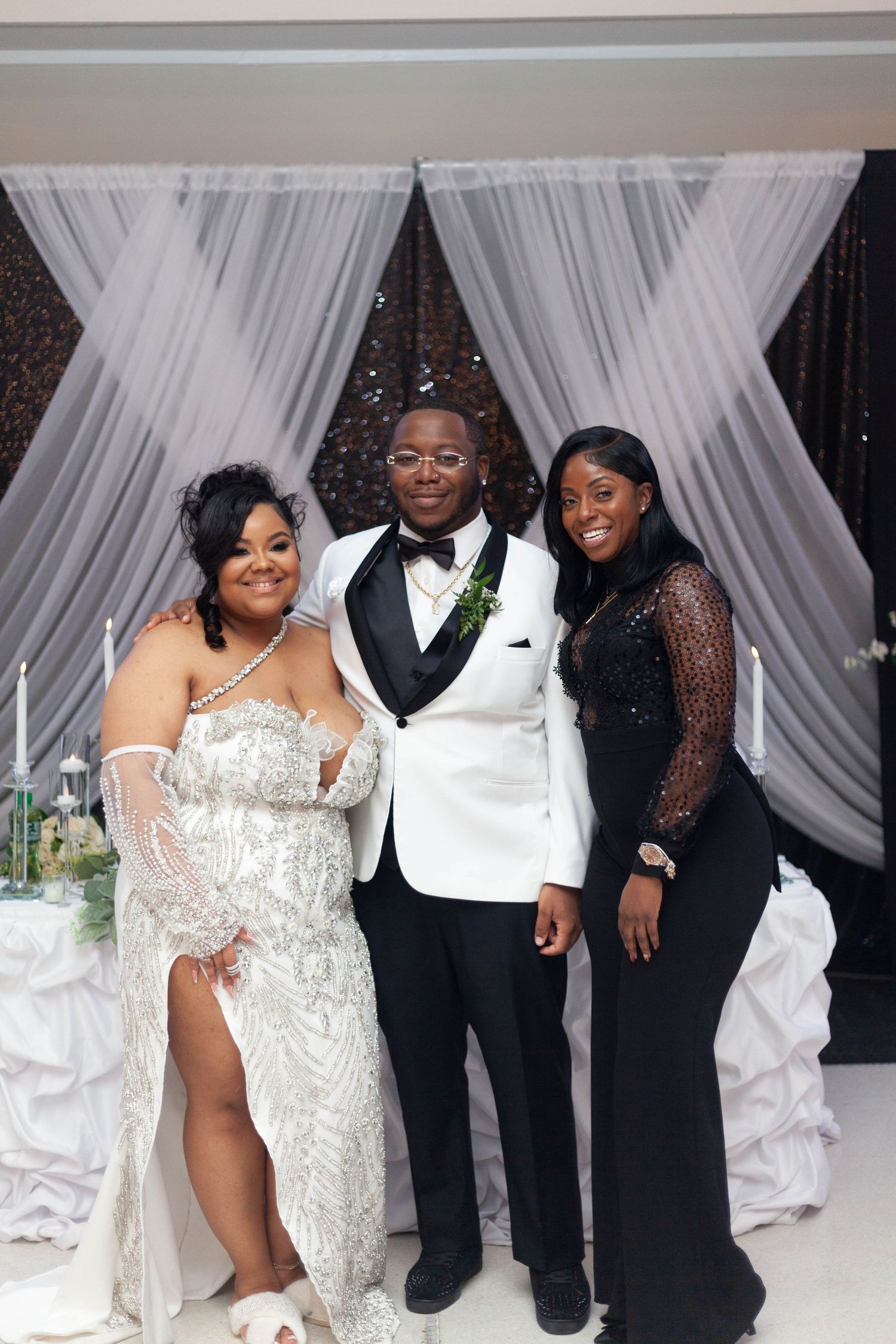 A wedding celebration sequence showing joyful moments with guests in formal attire against an elegant white draped backdrop.