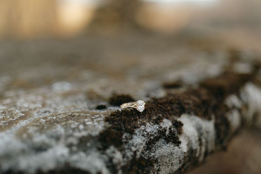 Macro view of coffee grounds scattered on a textured surface showing rich brown color and grainy texture details.