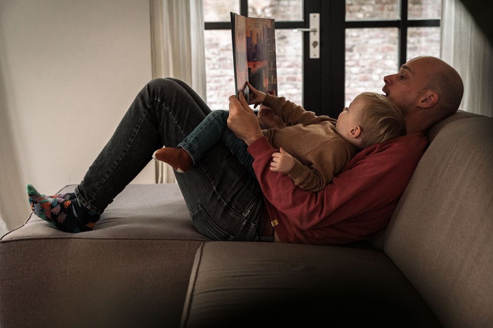 Person lying on a gray couch in casual clothing shown from multiple angles in a sequence of photos.