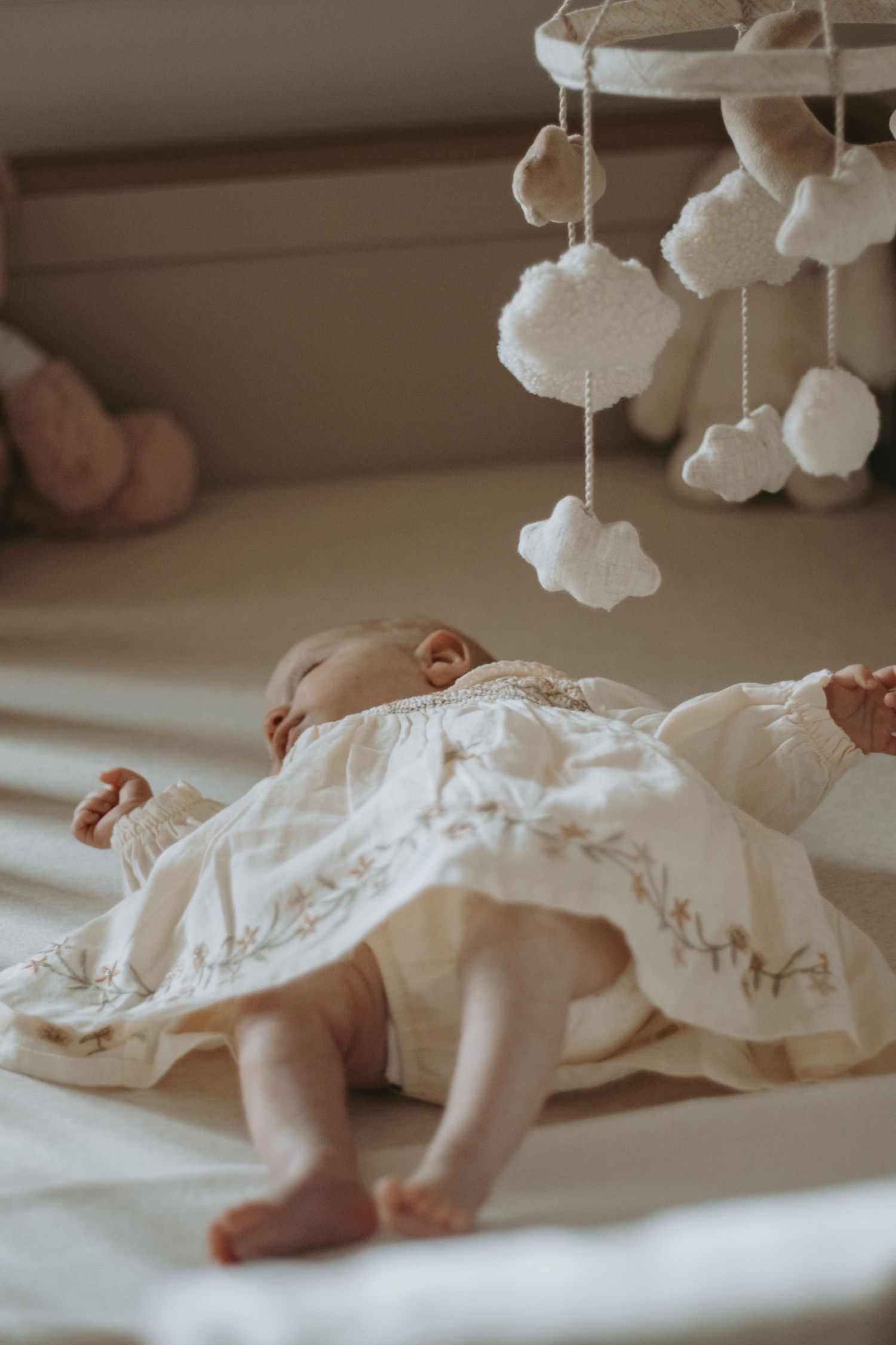 Peaceful newborn sleeping under soft knit blanket in natural light.