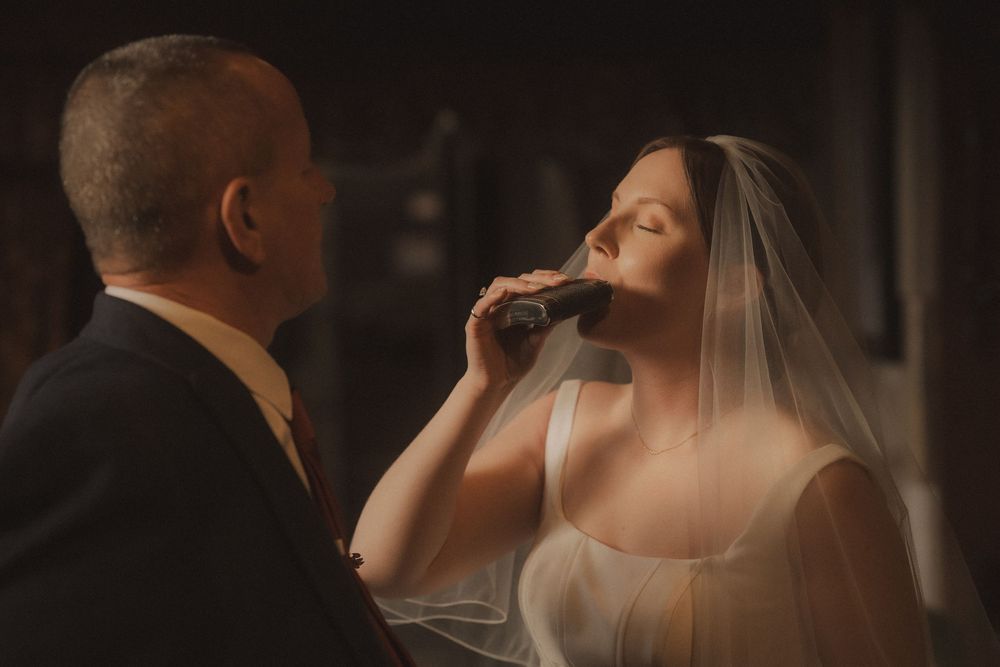 A romantic wedding couple shares an intimate moment during their first dance at an elegant reception venue.