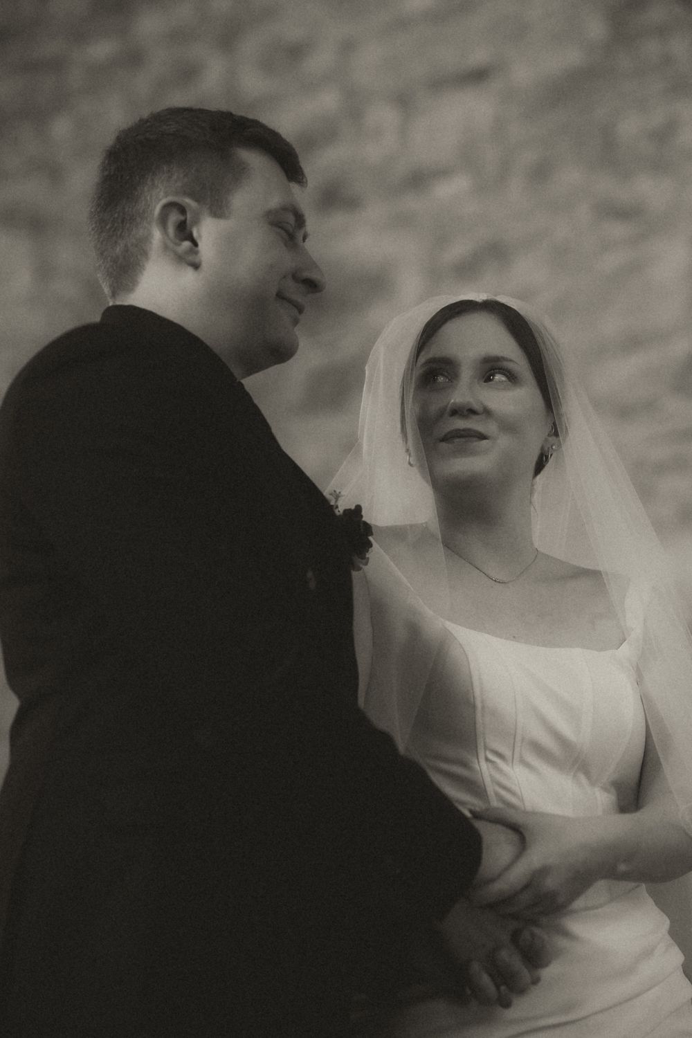 A black and white wedding photo sequence shows a romantic moment between a bride and groom in vintage style.