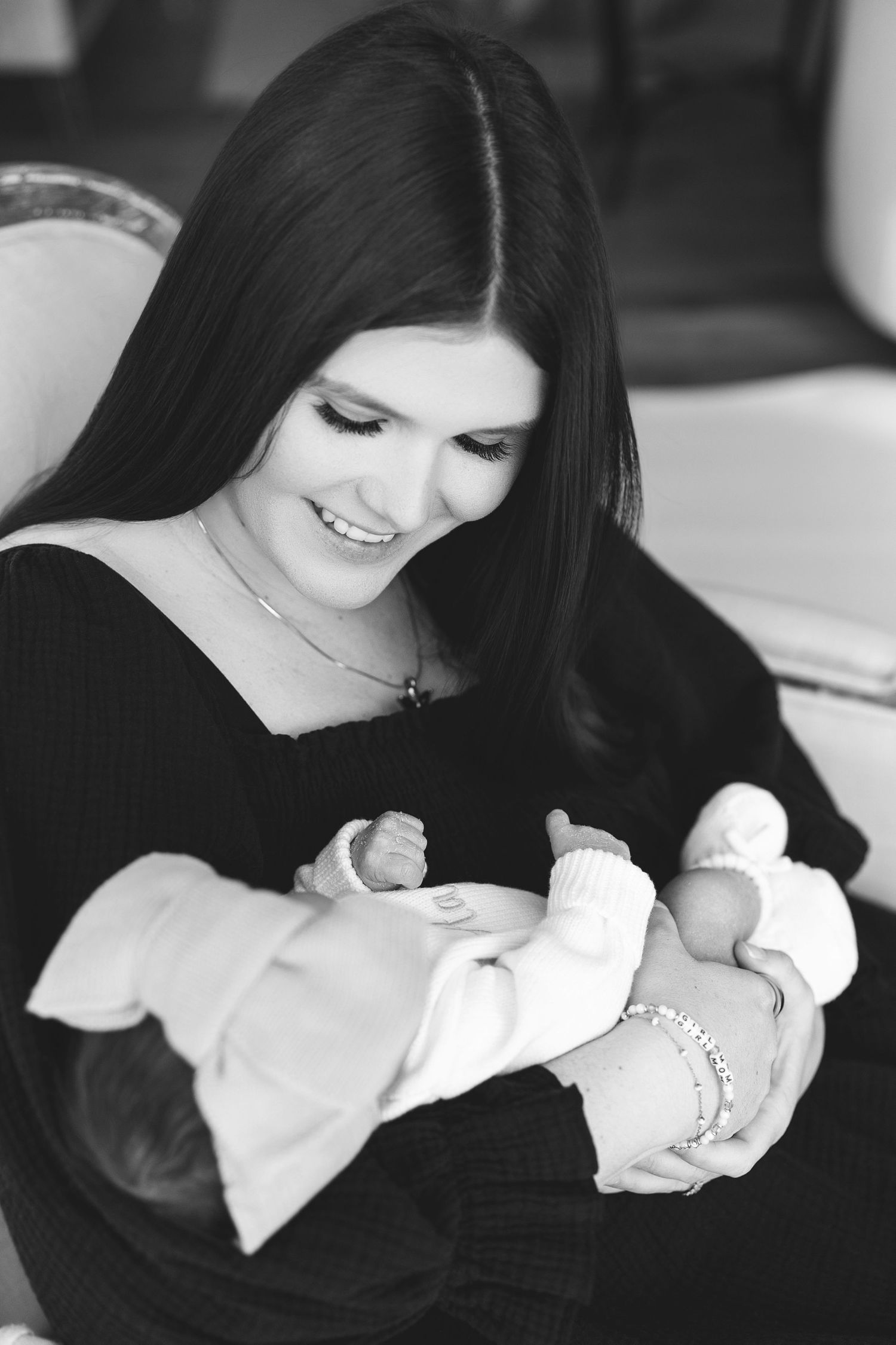 Black and white photos show tender moments between mother and newborn baby in a series of intimate portraits.