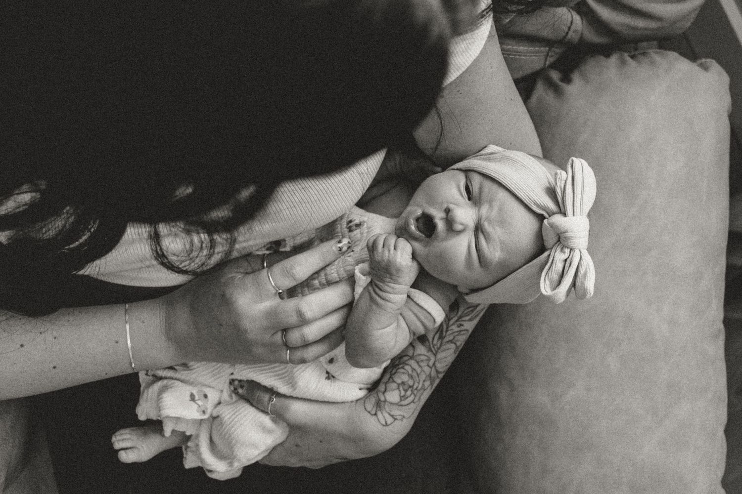 A series of vintage black and white photographs showing a baby being held and cared for in various poses.