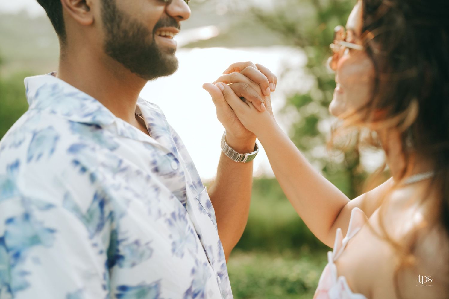 A couple in casual attire shares a tender dance moment outdoors.