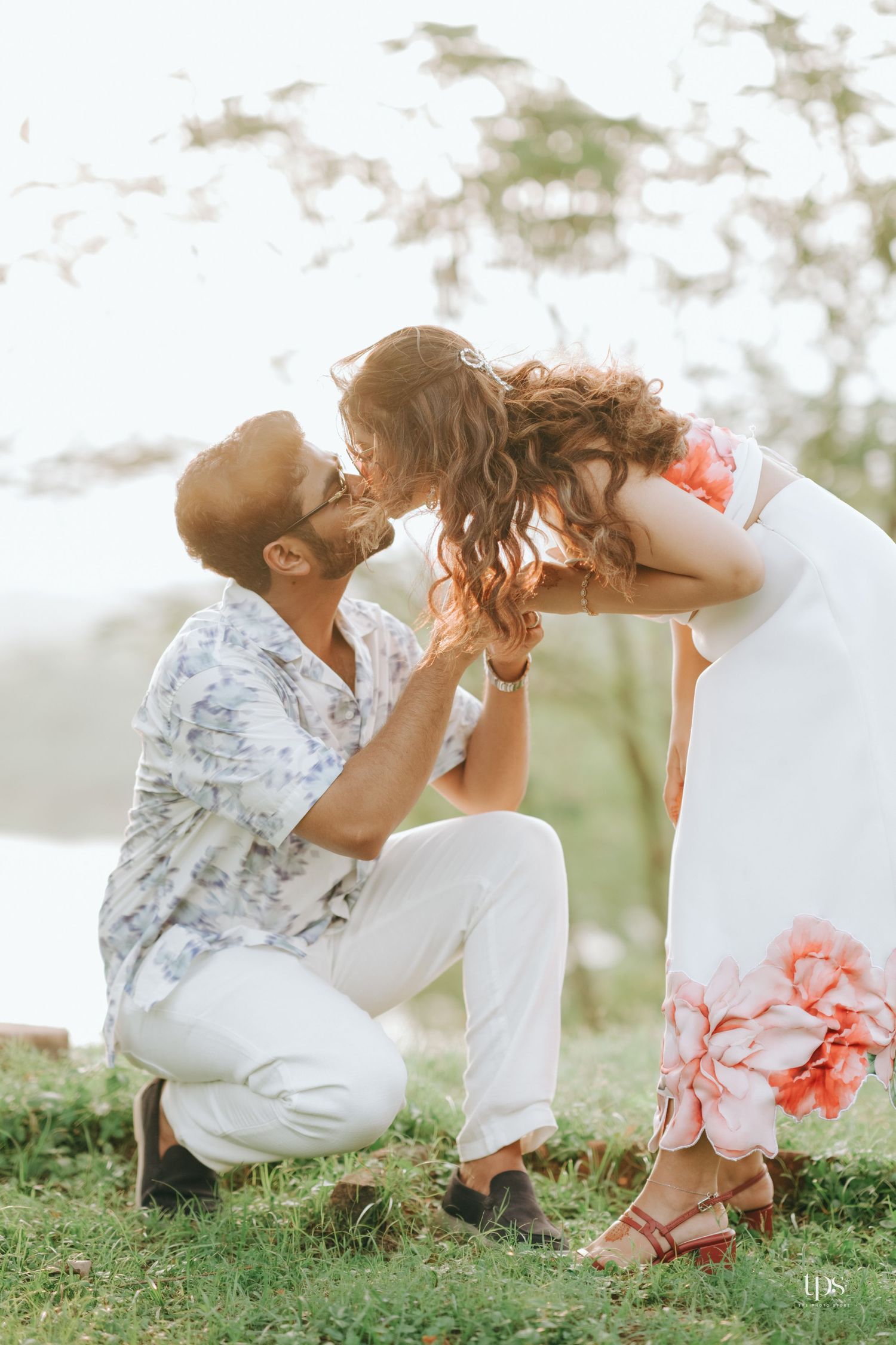 Intimate outdoor couple's photography session with white dress and floral accents.