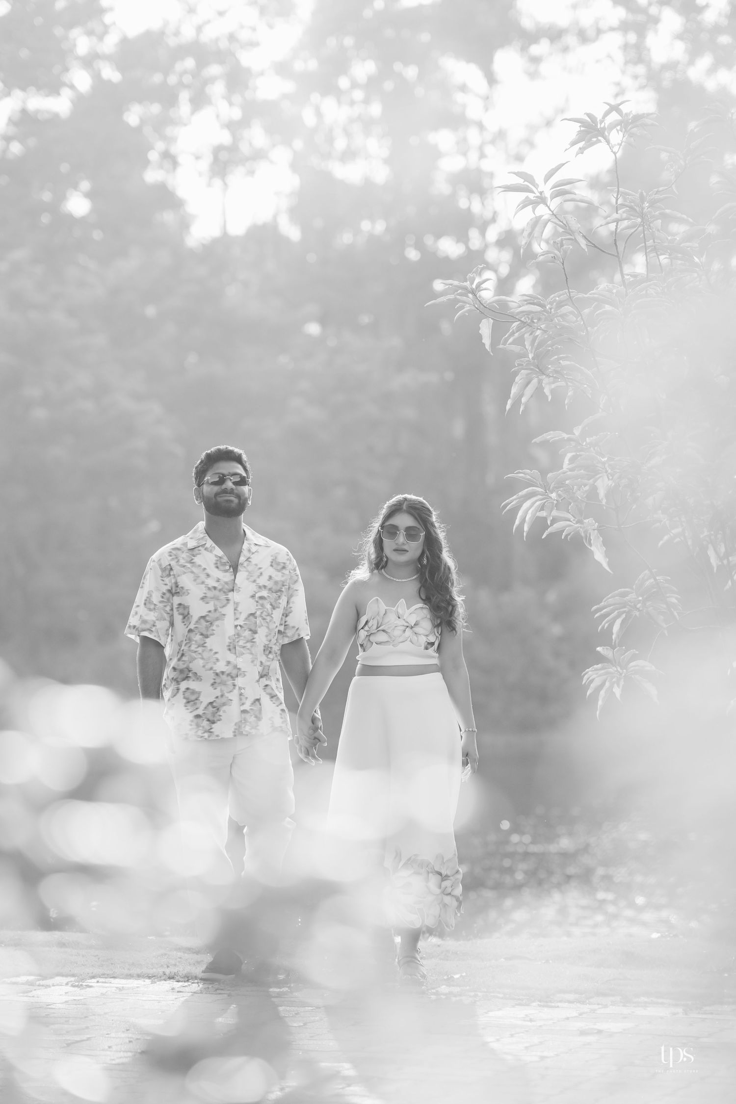 A black and white portrait in a misty garden setting with soft natural lighting.