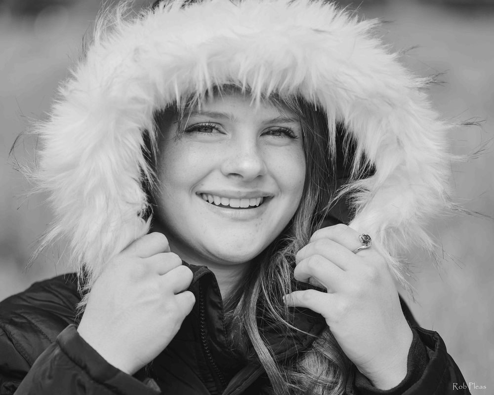 High school senior female wearing winter coat in Lupine fields near Farm 12 in Puyallup, WA