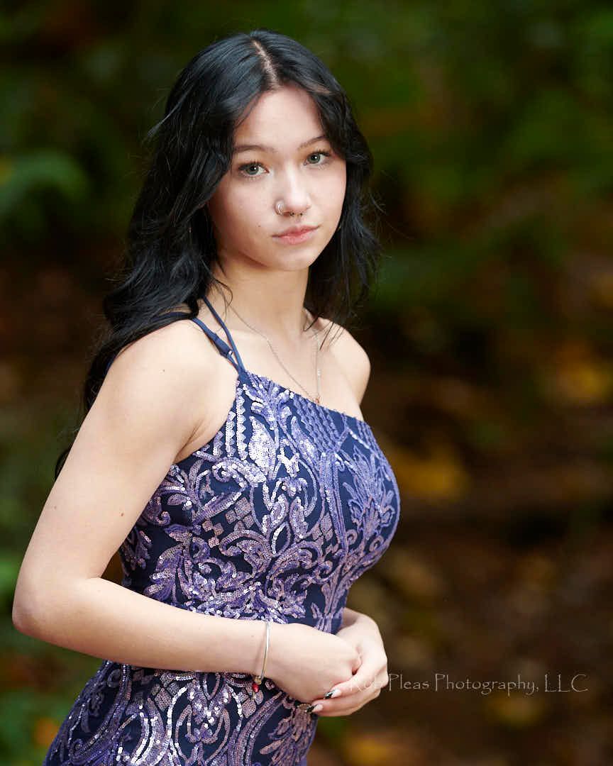 High school senior female wearing beautiful sparkle blue dress at Wildwood Park in Puyallup.