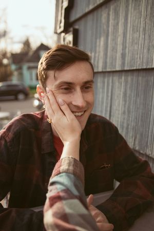 Series of close-up shots showing laughter and playful expressions against a wooden wall background.
