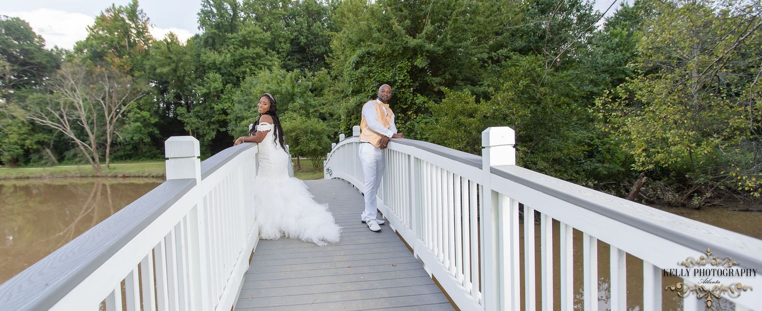 Outdoor wedding venue with white railings and natural greenery in the background.